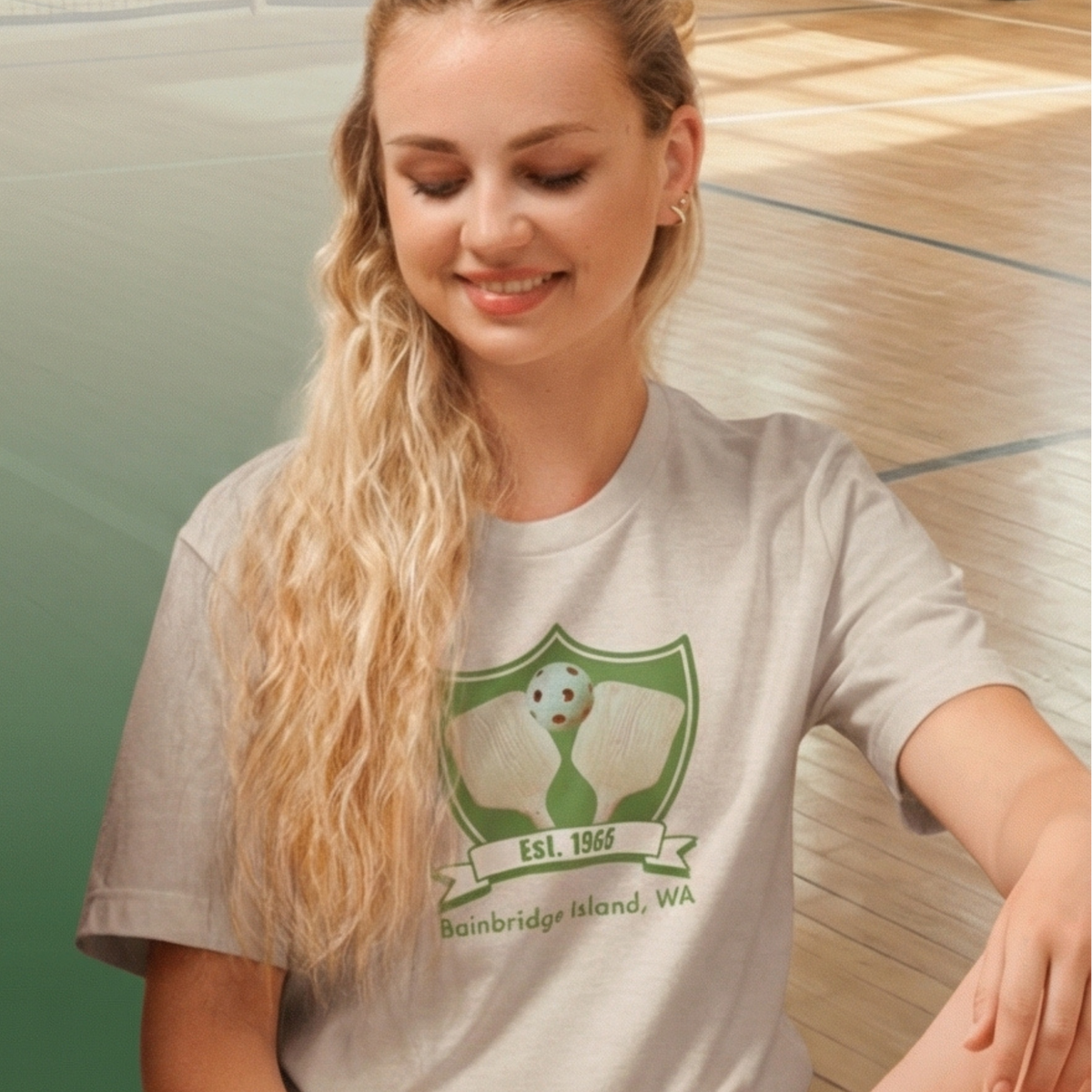 Bainbridge Pickleball Est. 1965 retro graphic tee on female model in a gym— Galactic Ink Club
