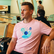 Bowling Retro-Inspired Graphic Tee on male model in pink in bowling alley setting — Galactic Ink Club