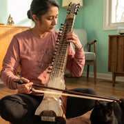 Mid-century Dilruba retro-inspired graphic long sleeve shirt on woman playing Dilruba instrument with bow beside sleeping black cat — Galactic Ink Club
