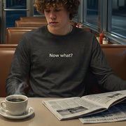 Now What? retro-inspired long-sleeve graphic tee worn by young man in retro diner at night — Galactic Ink Club