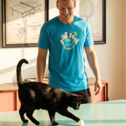 Ping Pong retro graphic tee on male model in teal with black cat playing with a ping pong ball in game room setting — Galactic Ink Club
