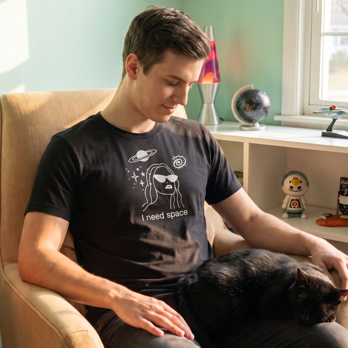 Stargazer Retro-Inspired Graphic Tee retro graphic t-shirt on man sitting indoors — Galactic Ink Club

