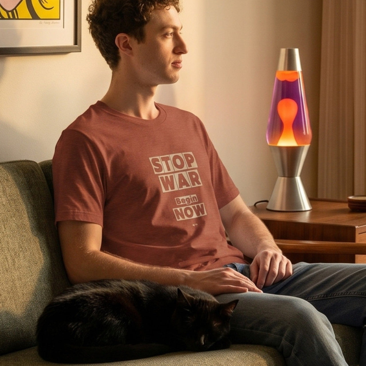 Stop War retro-inspired graphic tee worn by man on mid-century modern sofa with black cat and lava lamp — Galactic Ink Club