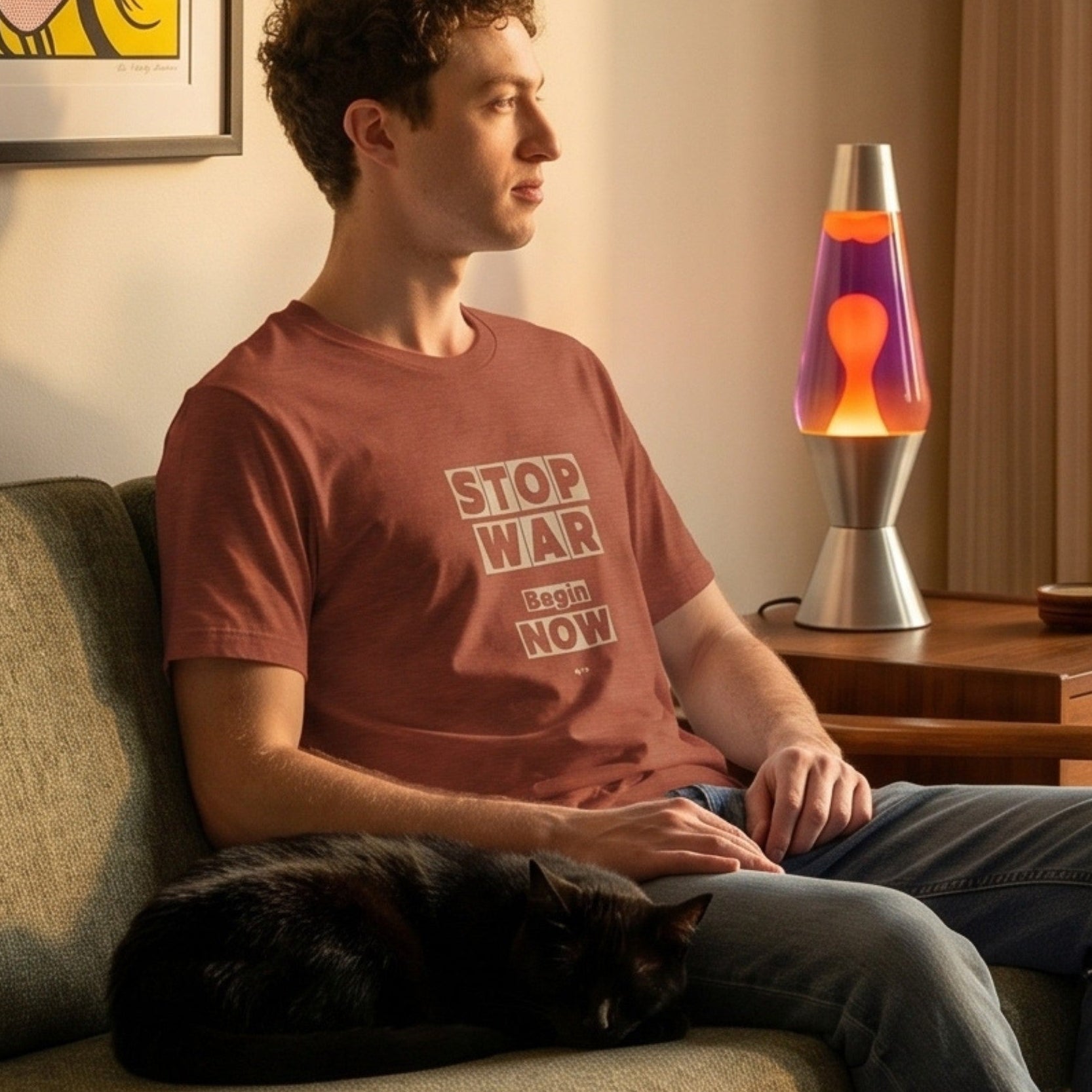 Stop War retro-inspired graphic tee worn by man on mid-century modern sofa with black cat and lava lamp — Galactic Ink Club