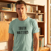 Truth Matters retro-inspired graphic tee light edition worn by person in mid-century modern setting — Galactic Ink Club

